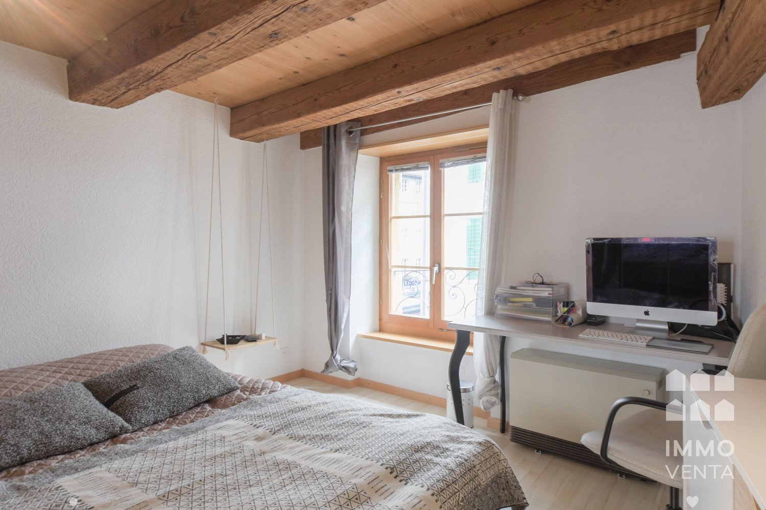 wooden ceiling, bed, wooden floor, desk, computer, window with curtain