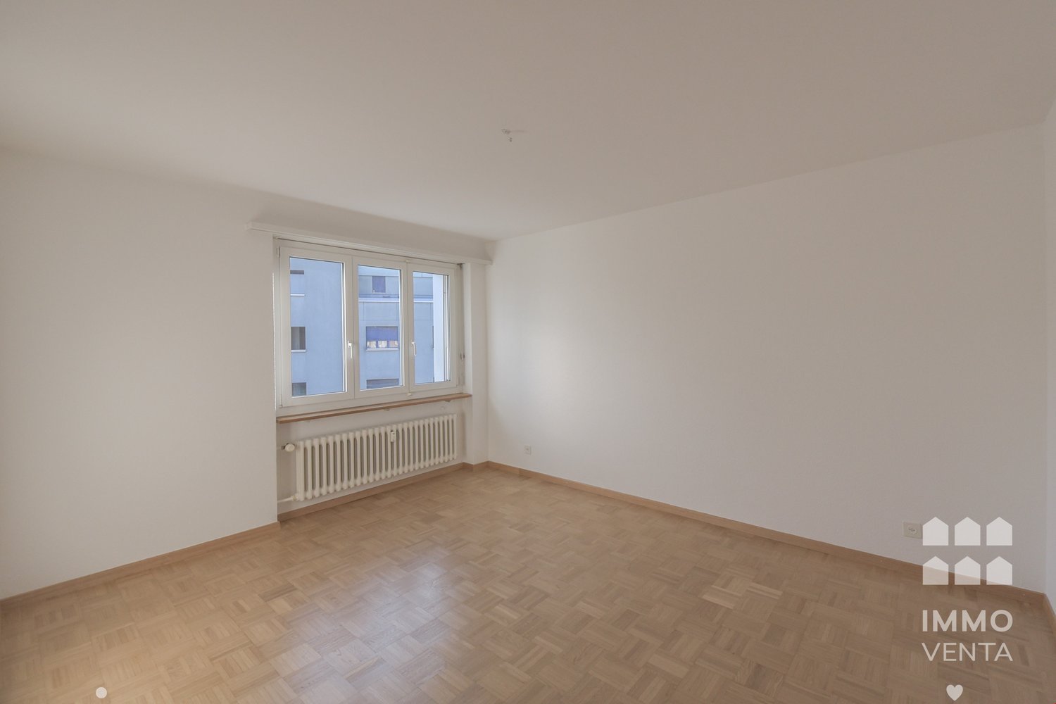 large window, radiator, wooden floor