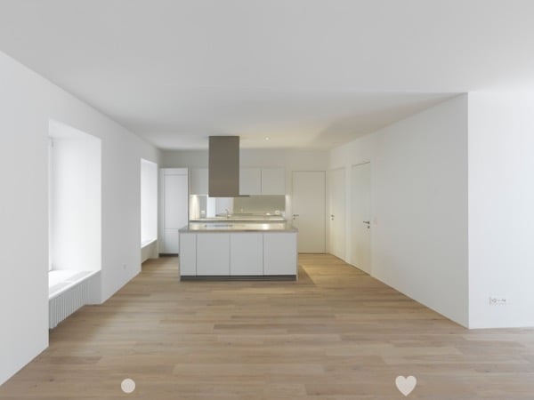 Open kitchen, white cabinets, wooden floor, white walls, central island, modern design