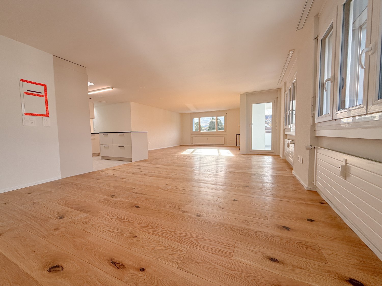 empty room, hardwood floors, sliding glass door, windows, cabinet