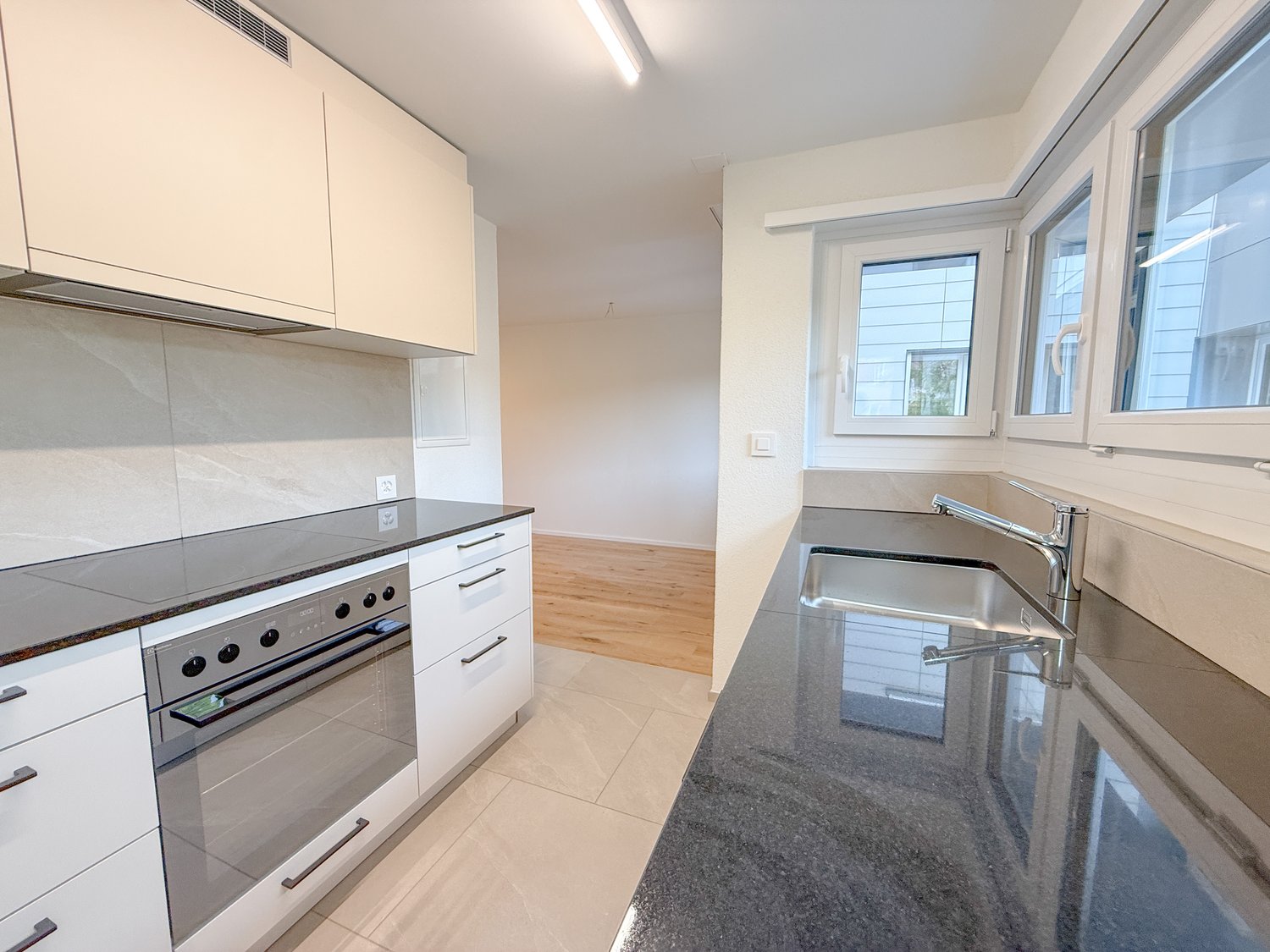 stainless steel appliances, granite countertops, white cabinets, oven, dishwasher, sink with faucet