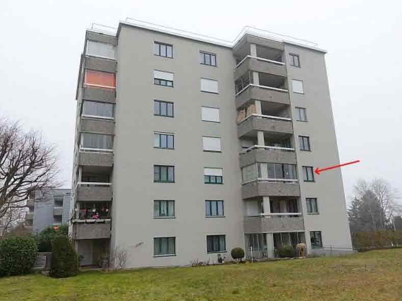 Modern multi-story building with balconies and many windows