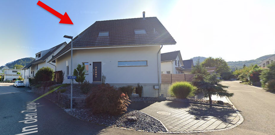 Raised ground floor house, brown roof, white walls, small garden, streetlight