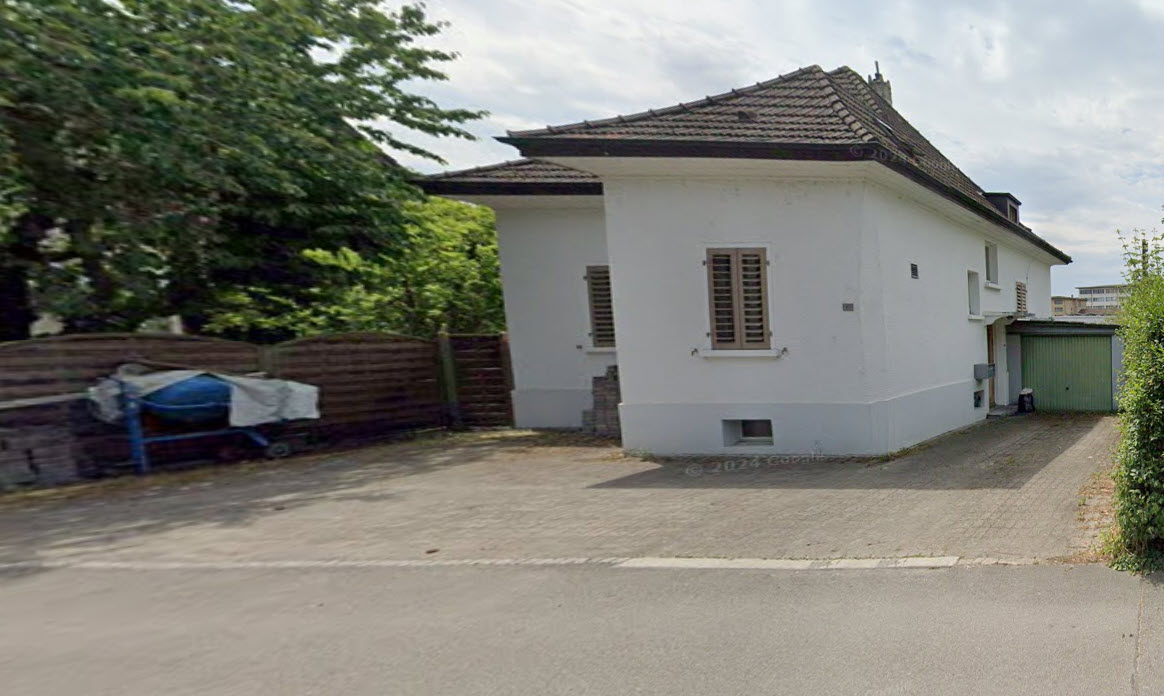2 story house, white exterior, brown roof, fenced yard, concrete driveway, small shed, multiple windows