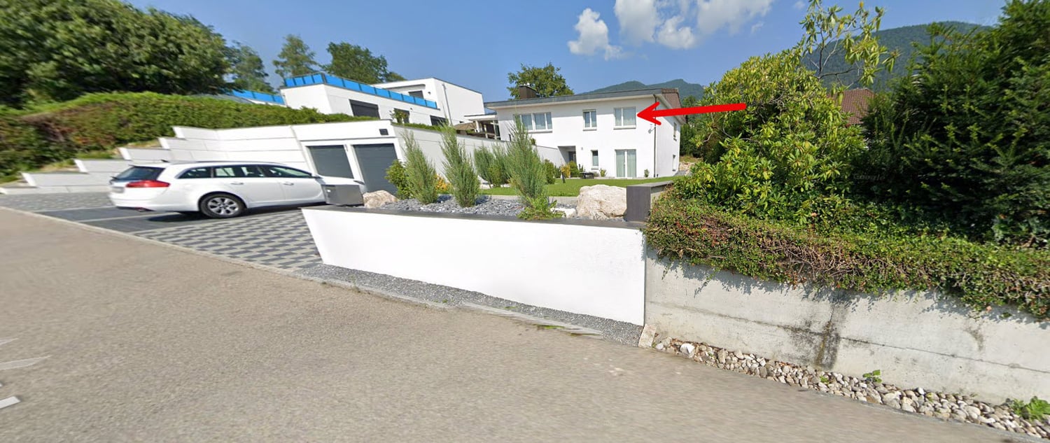 modern white house, garage, white wall on side, driveway, white car parked