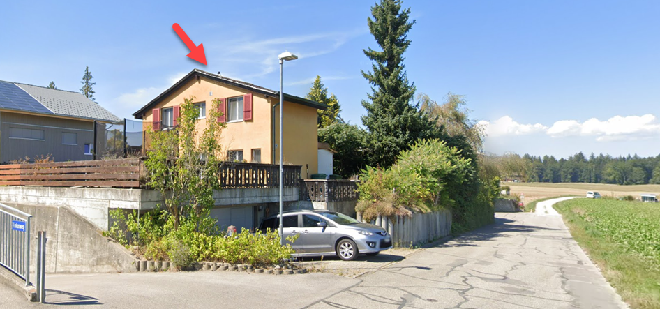 2 story house, yellow facade, gable roof, garage, driveway