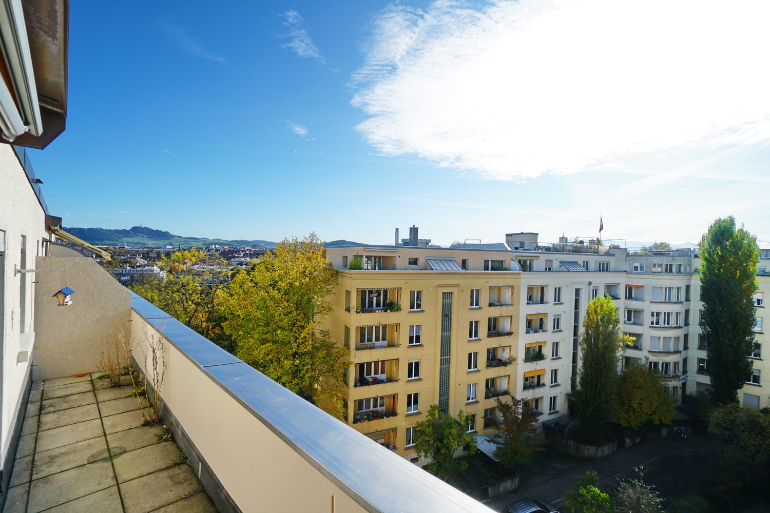 Yellow building with multiple balconies and a view of the town