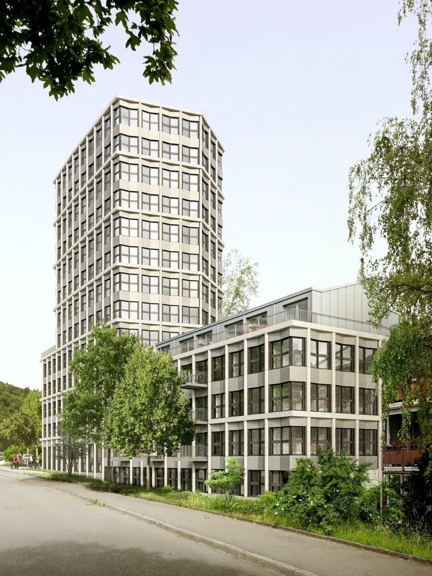Modern apartment building with balconies, multiple floors, concrete structure, large windows, surrounded by greenery.