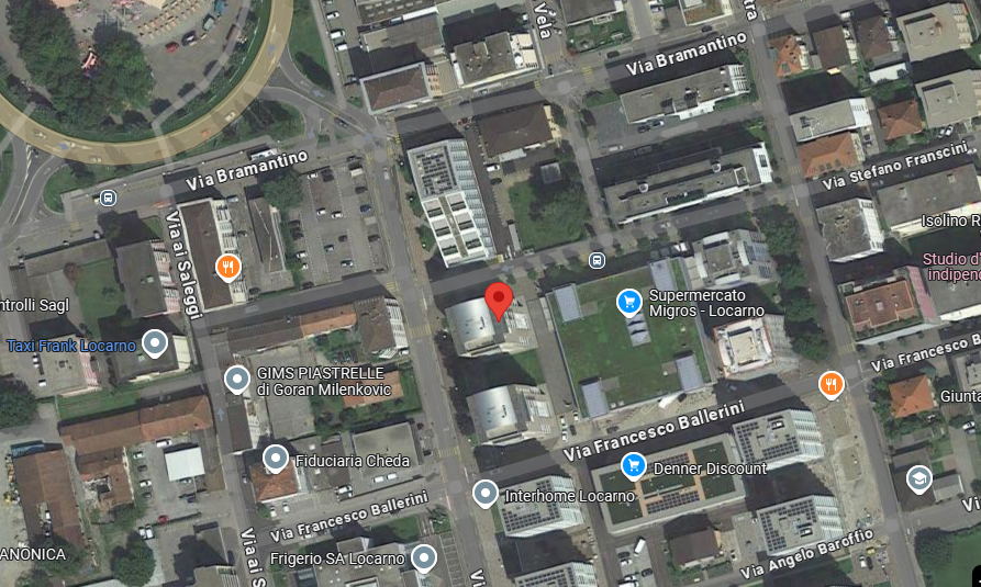 The image shows a satellite map view of a residential and commercial area in Locarno, Switzerland. The map includes various landmarks such as a Supermercato Migros supermarket, Denner Discount store, and Fiduciaria Cheda. The streets visible in the map in