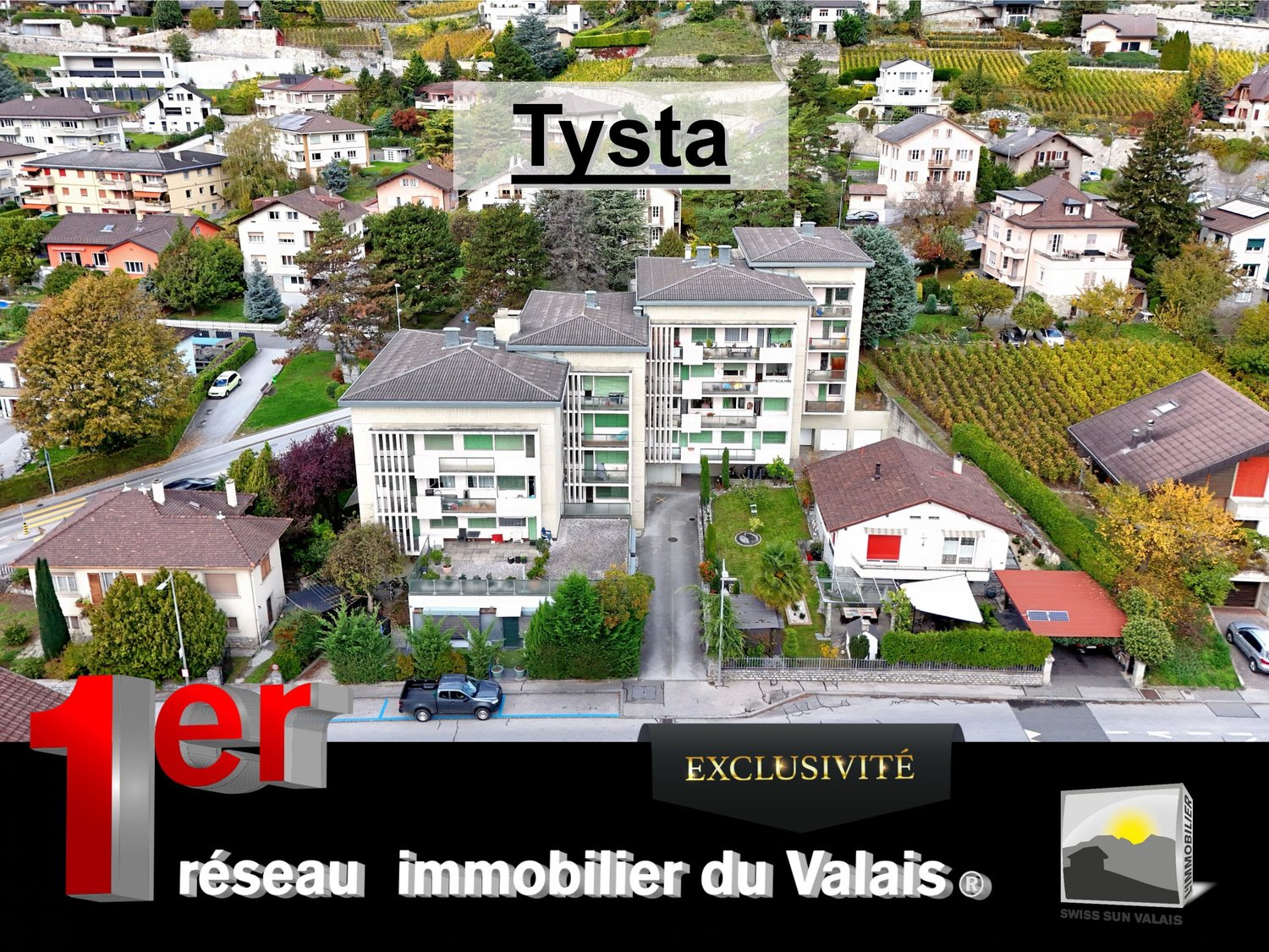Mountain view, modern apartment building, with multiple houses surrounding, large windows, surrounded by trees, driveway in front