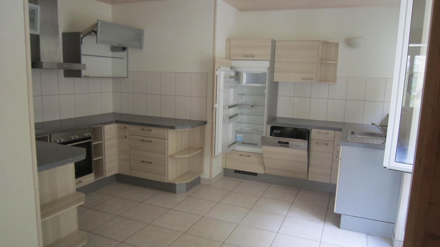 Wood cabinets, tile floor, refrigerator with freezer, dishwasher, gas stove, electric oven, wooden counter top