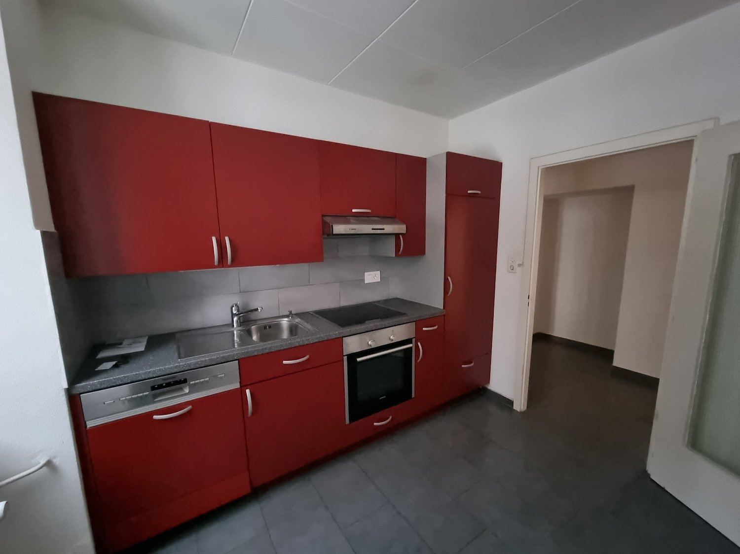 Red cabinets, stainless steel appliances, granite countertop, modern kitchen design