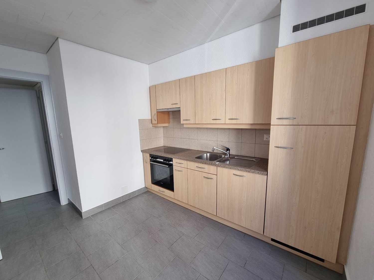 modern kitchen with wooden cabinets, granite countertop, integrated oven and dishwasher, sink with faucet