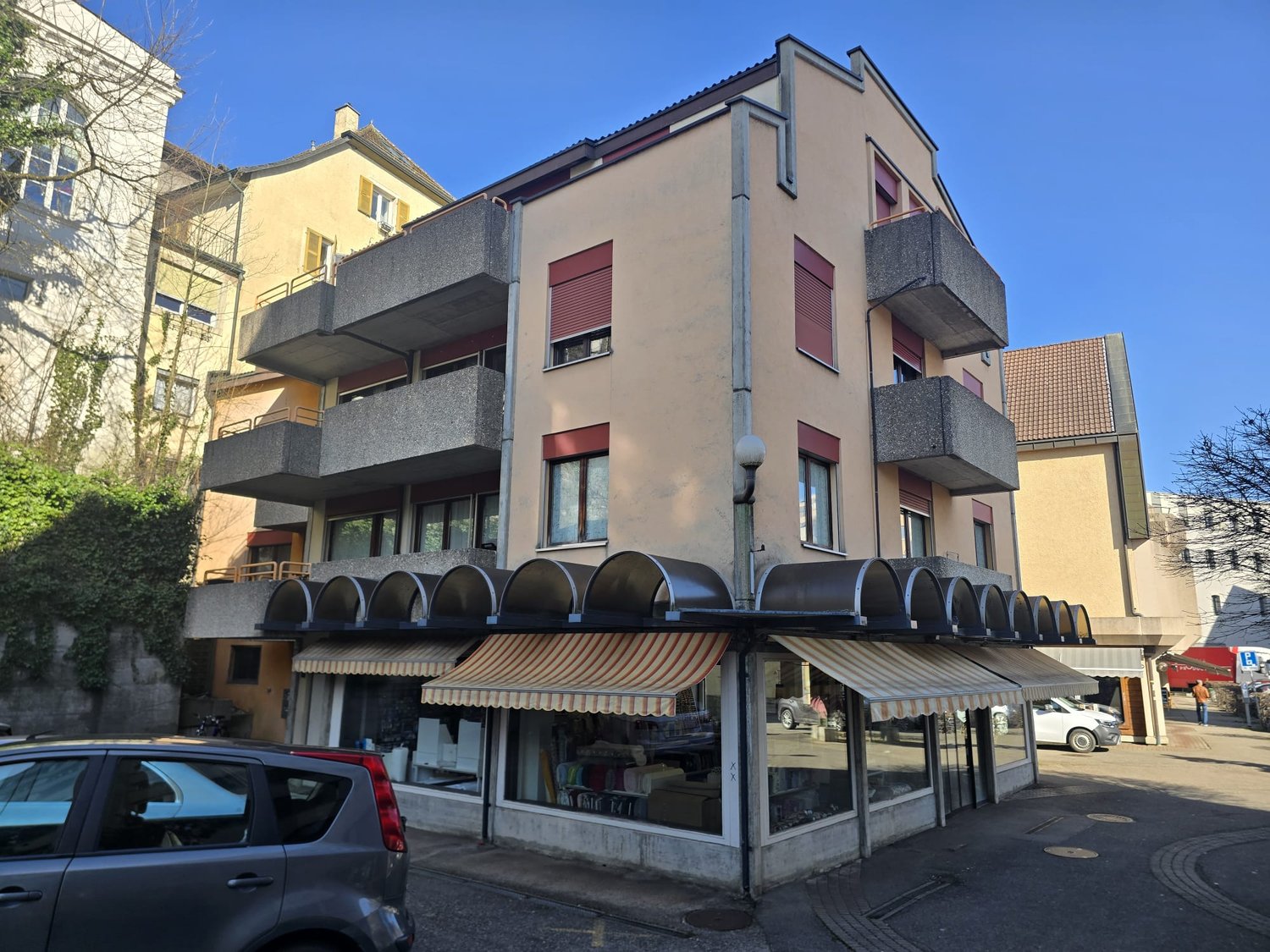 3 story building, balconies, awnings, storefront