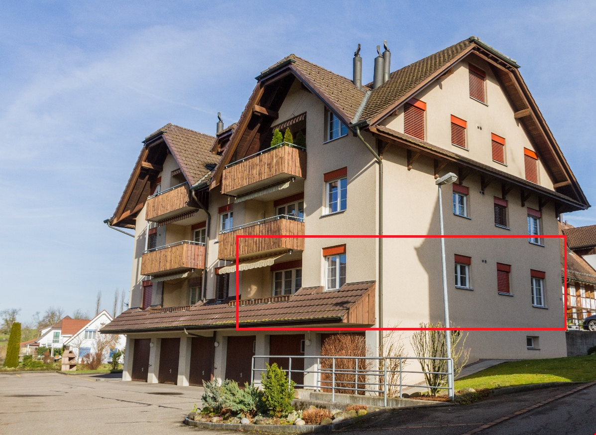 4-storey apartment building, brown roof, multiple balconies, garage, streetlight