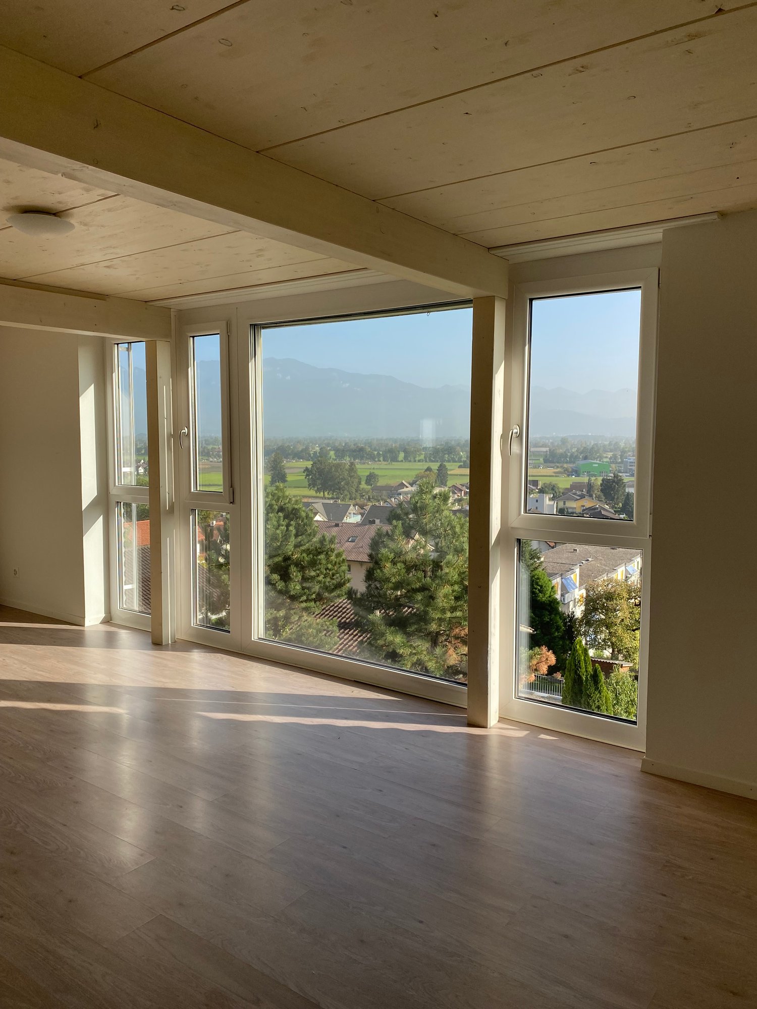 large windows, countryside view, parquet floor, beams