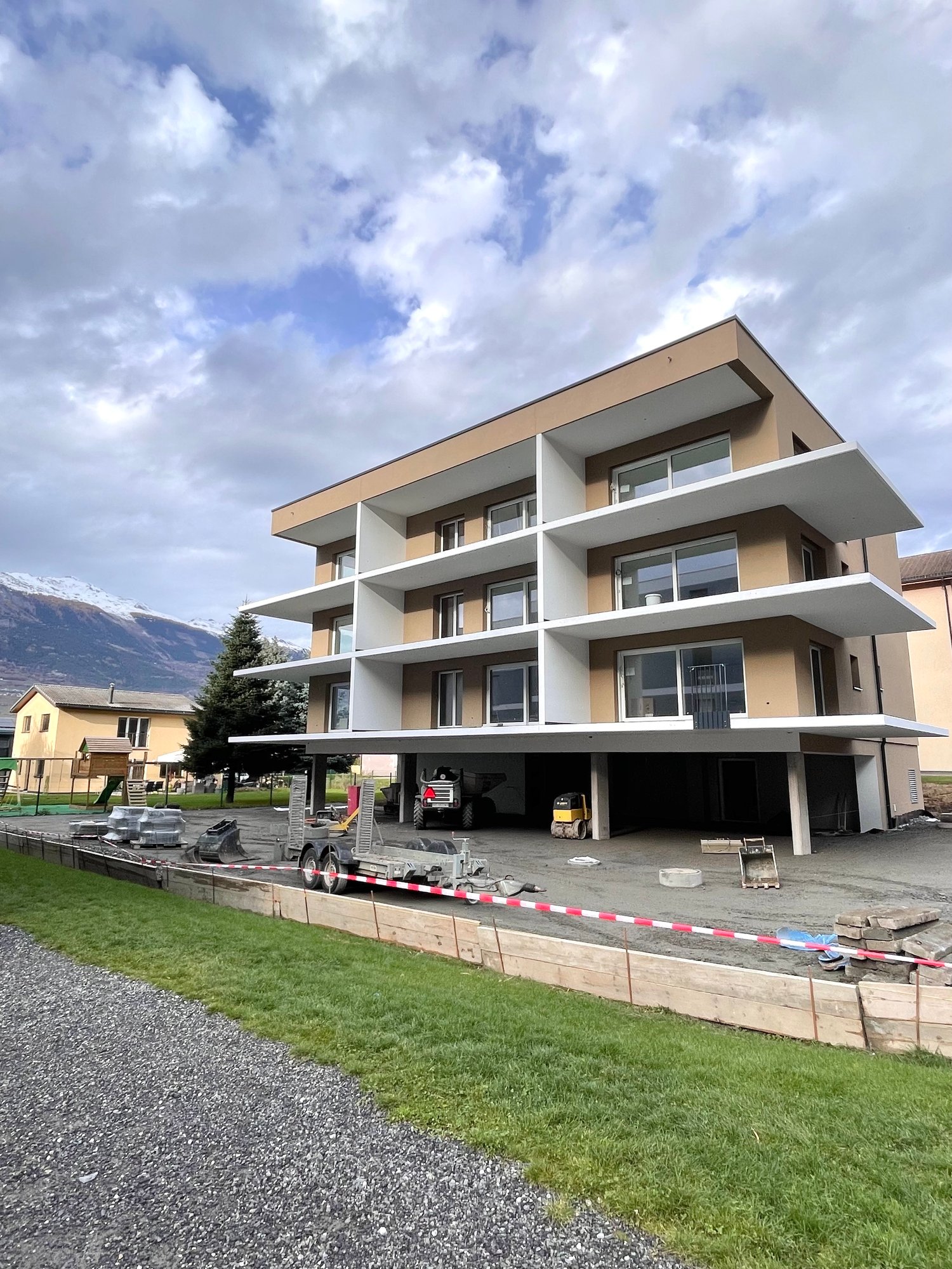modern apartment building under construction, white and brown color scheme, glass windows, multiple floors, attached garage