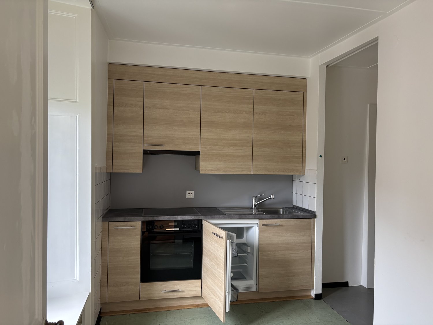 modern wooden cabinets, granite countertop, stainless steel sink, oven, refrigerator