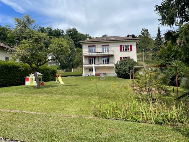 White house, 2 story, 4 windows on 1st floor, 3 windows on 2nd floor, balcony, garden, playground