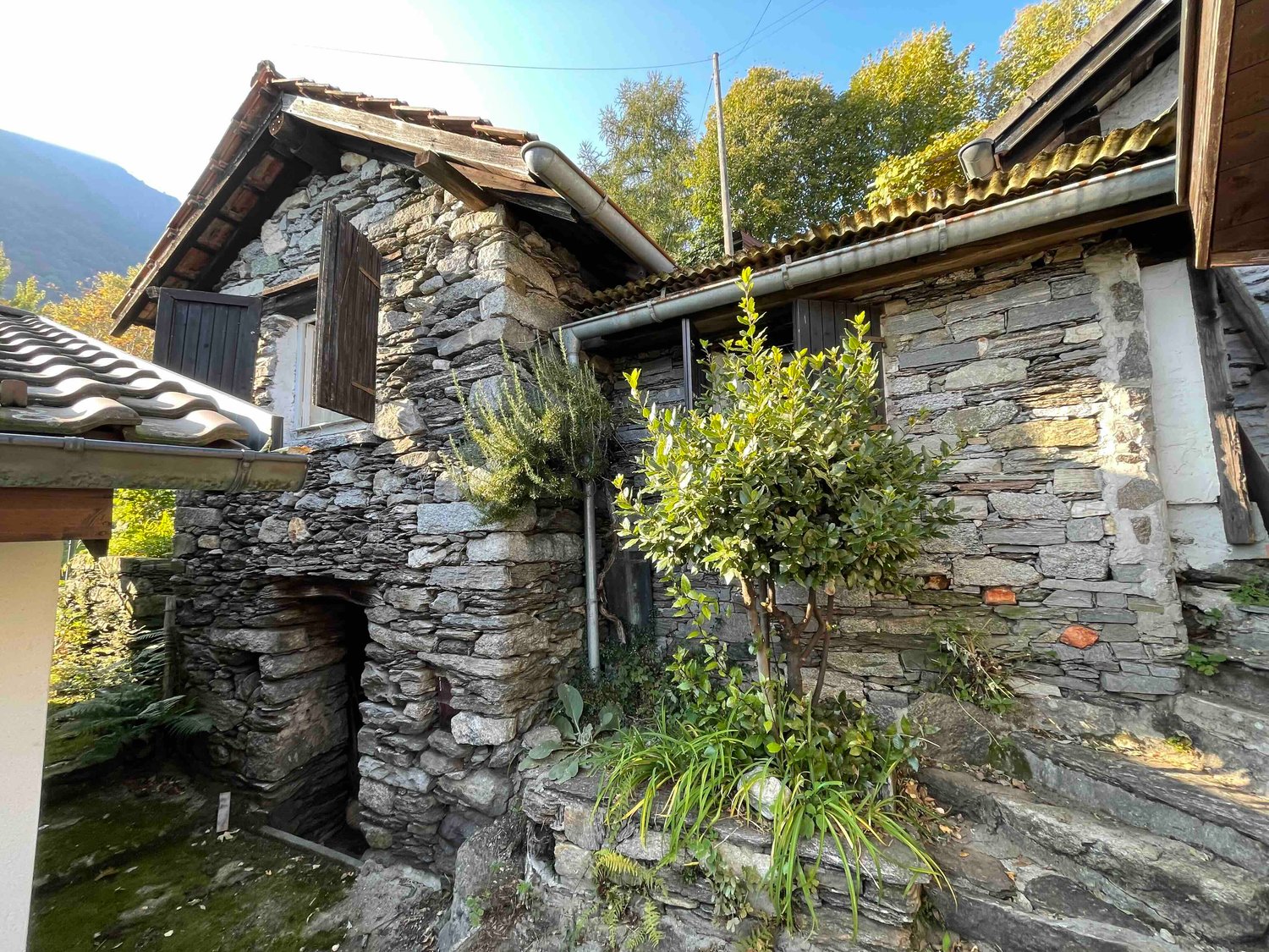 Stone house, wooden roof, wooden door, garden, mountain view