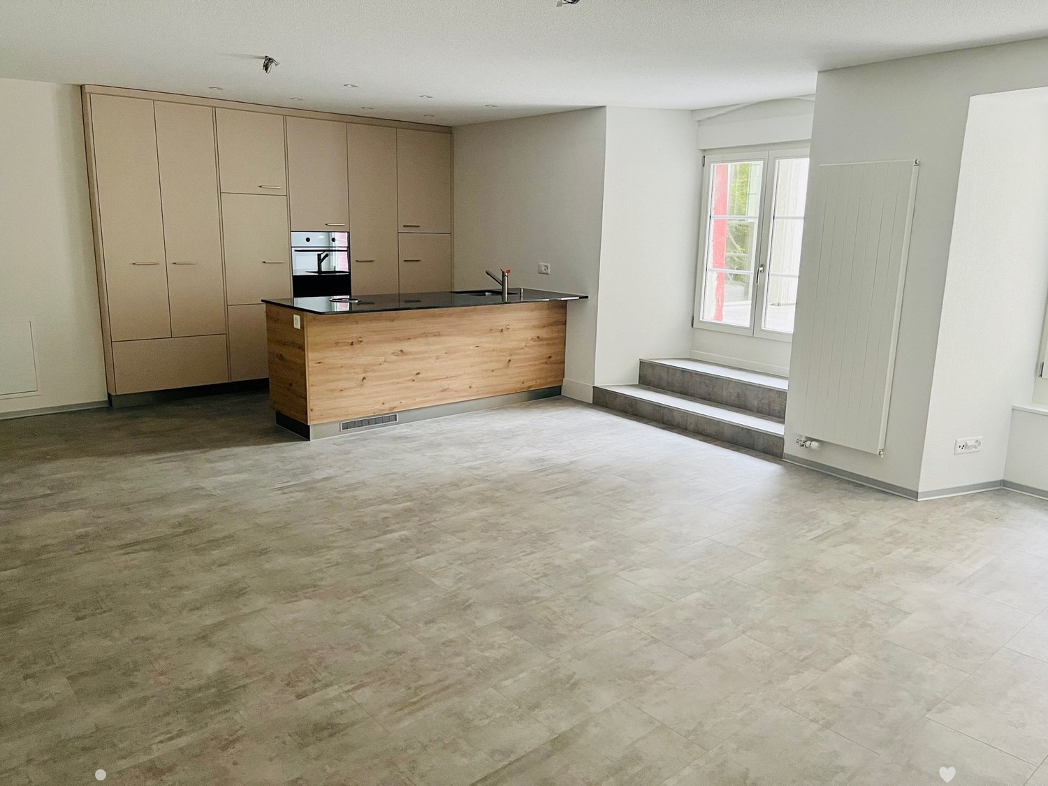 empty kitchen, wooden island, tiled floor, white walls, open cabinet, oven, sink, faucet, large window, steps