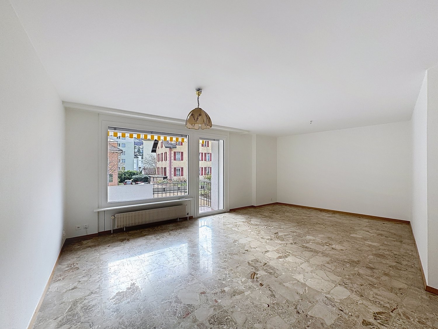 Large window, white wall, white ceiling, large tile floor, glass doors