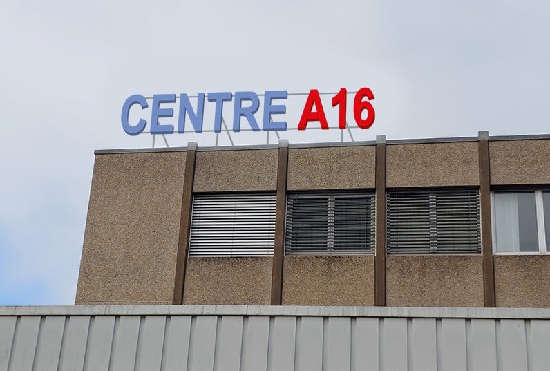 A multi-story commercial building with the sign 'CENTRE A16' displayed prominently on the facade.