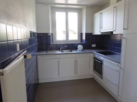 U-shaped kitchen with white cabinets, blue tile backsplash, and stainless steel appliances including a dishwasher.