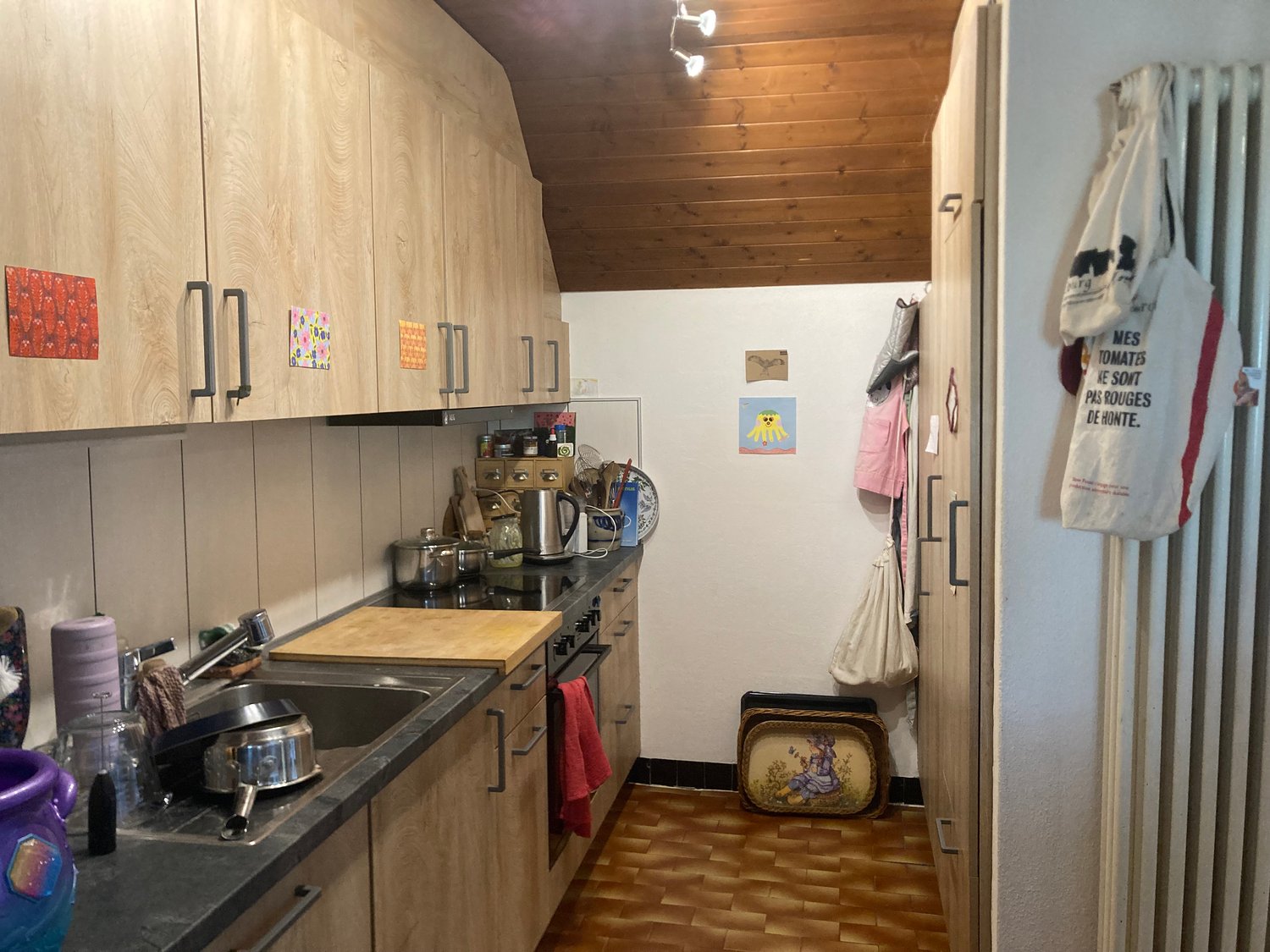 kitchen, wooden cabinets, countertops, gas stove, sink, dishwasher, kettle, chopping board, various cookware, cabinets on the wall