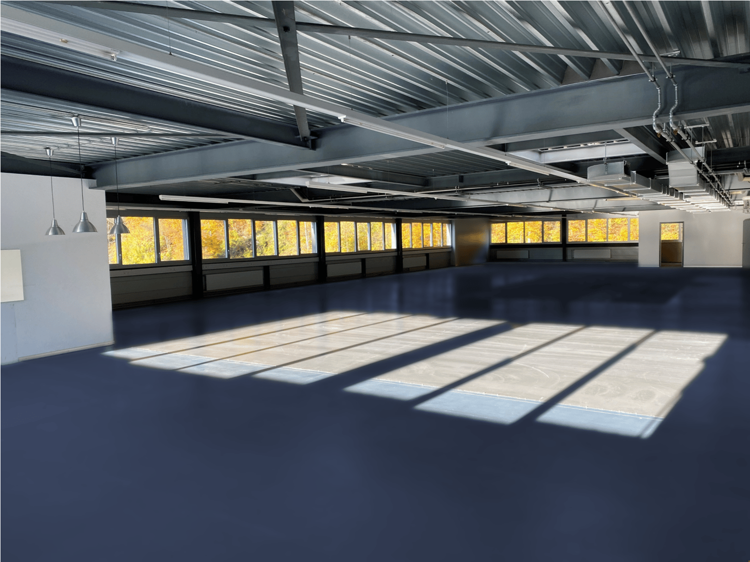 empty room, steel ceiling, blue floor, large windows, sunlight