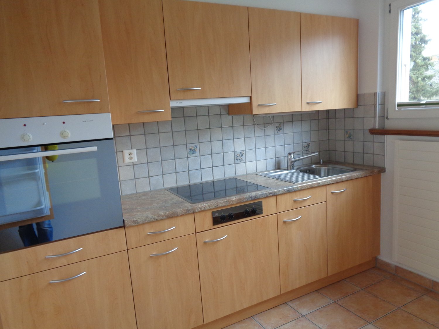 light wood cabinets, gas stove, electric oven, sink, dishwasher, window