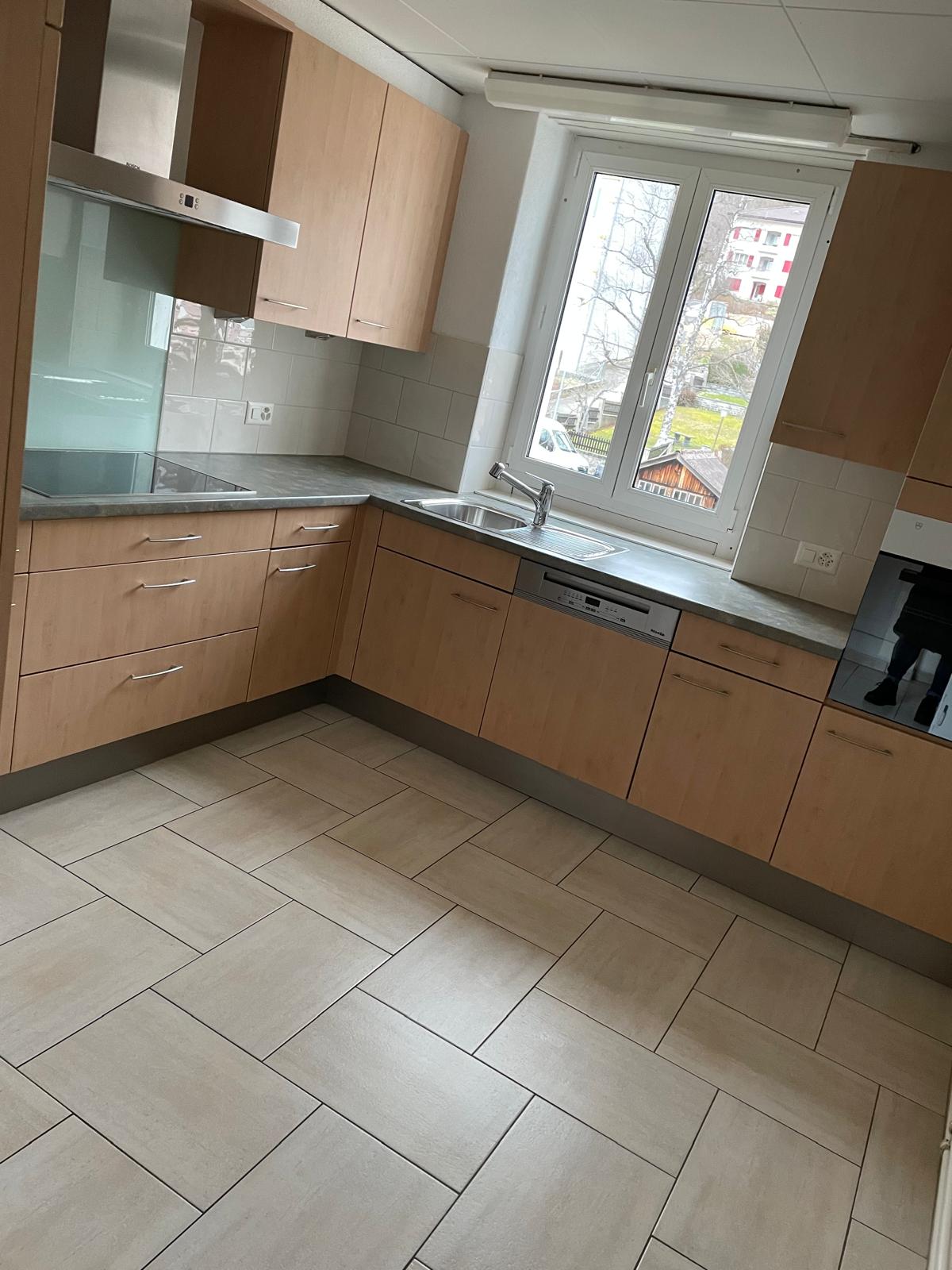 modern kitchen, tiled floor, white tiled backsplash, stainless steel appliances, wooden cabinets, double sink, dishwasher