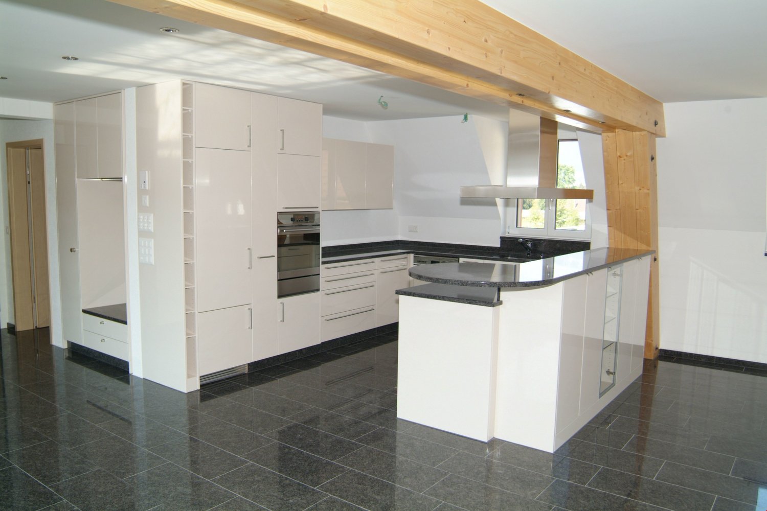 kitchen, island, modern cabinets, black countertops, tiled floor, oven