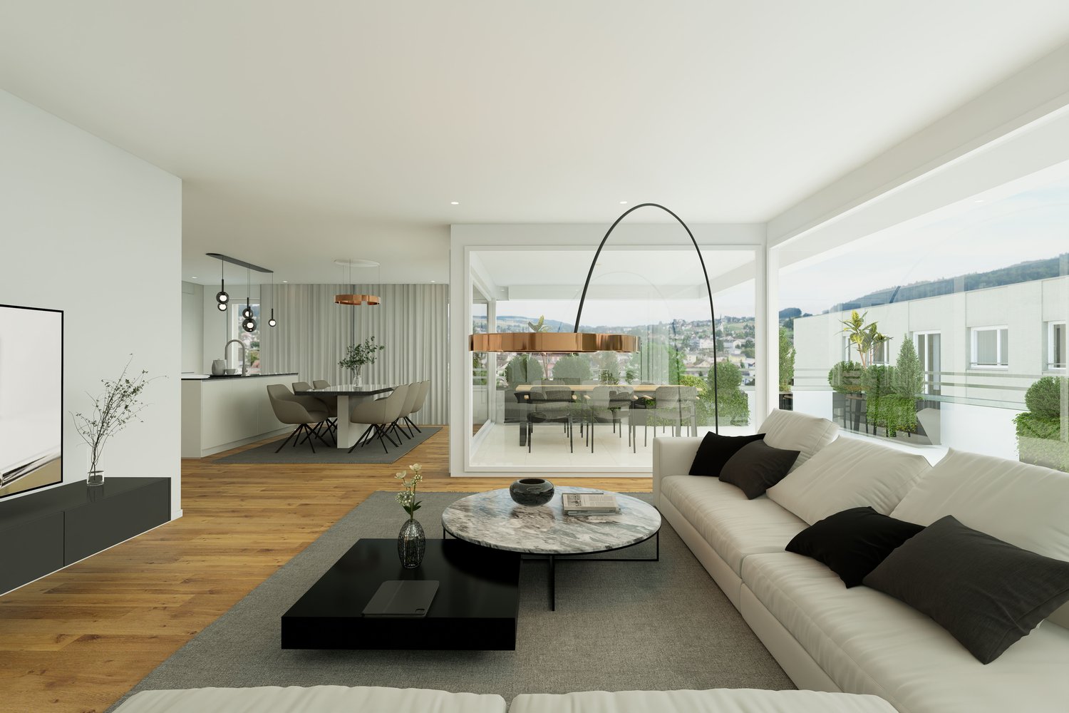 Spacious open-plan living area with large windows, hardwood floors, modern furniture including a sofa, coffee table, and dining table with chairs. The room has a balcony or terrace overlooking the city.