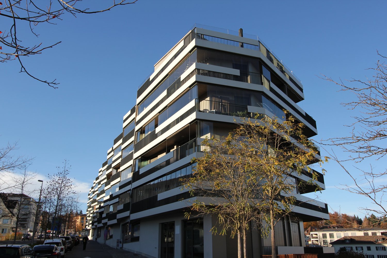 Multistory building, modern architecture, glass facades, balconies, corner placement