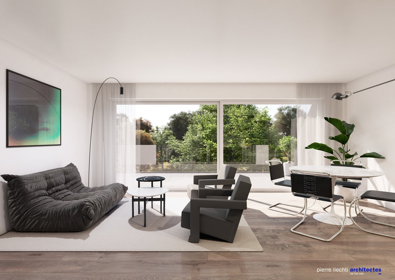 Spacious living room with large windows overlooking a lush, green outdoor area. The room features a grey sofa, black armchairs, a white dining table with chairs, and a potted plant. The walls are white, and the floor is made of wood. There is also a frame