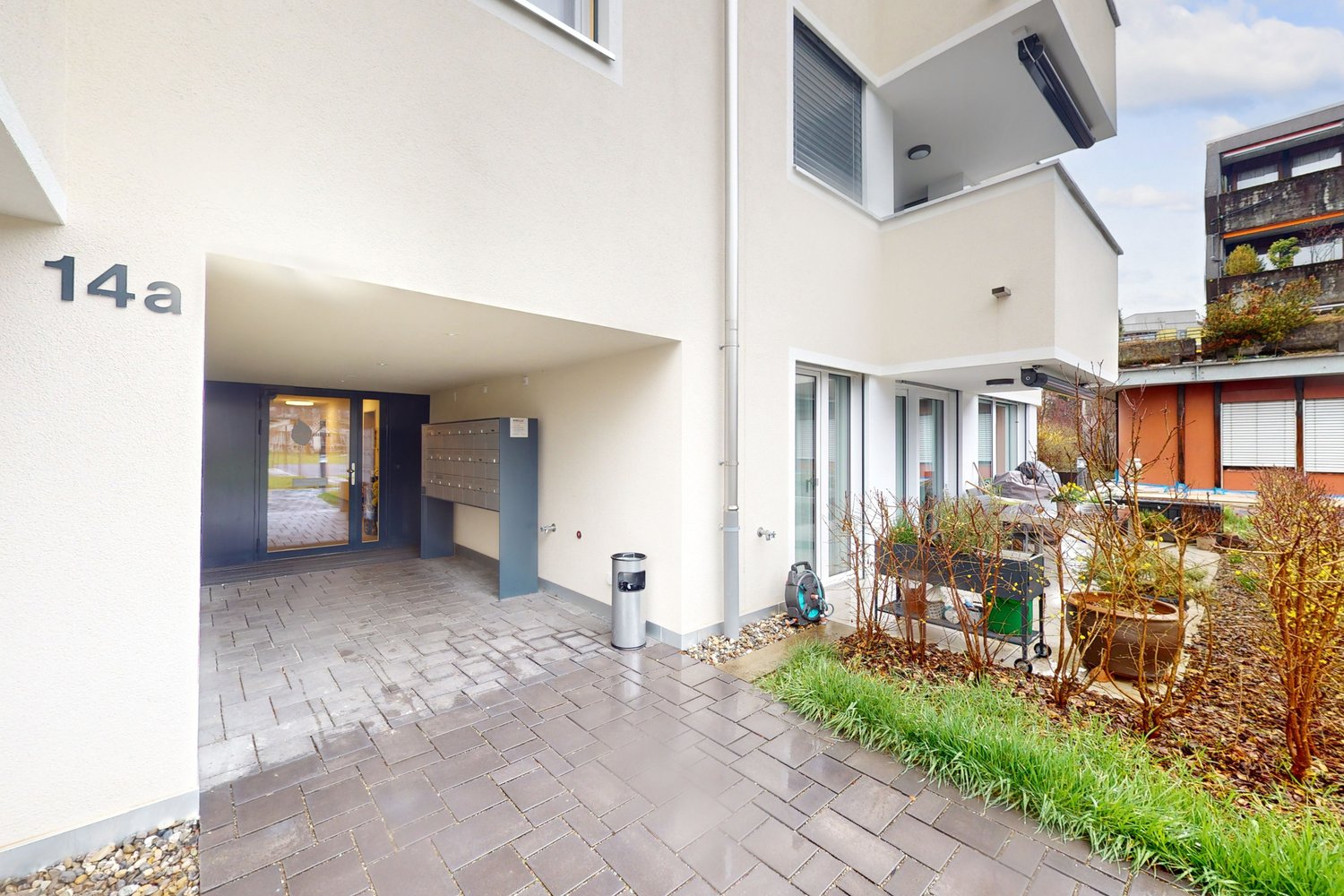 White bricked building, entry with number 14a, mailbox