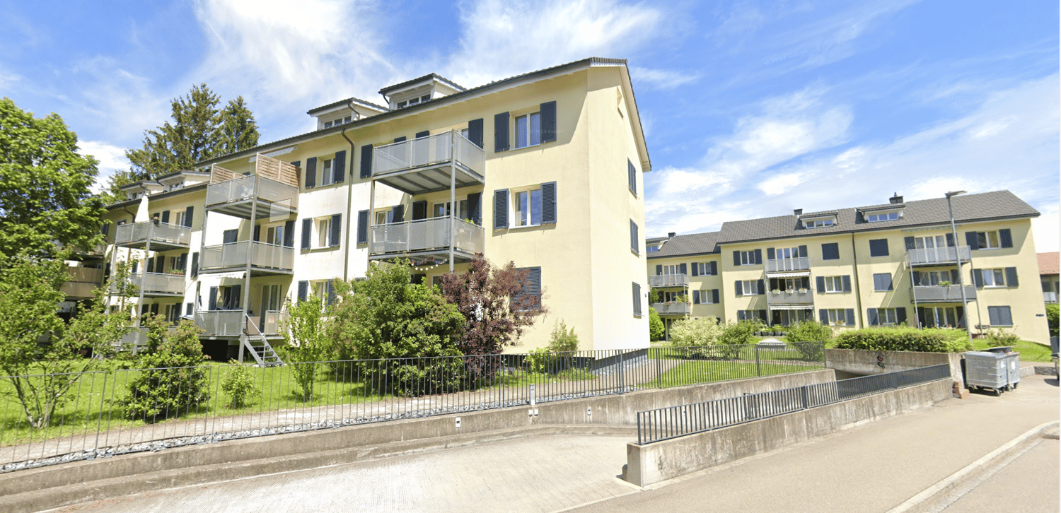 multi story building, balconies, concrete pathway, plants and trees
