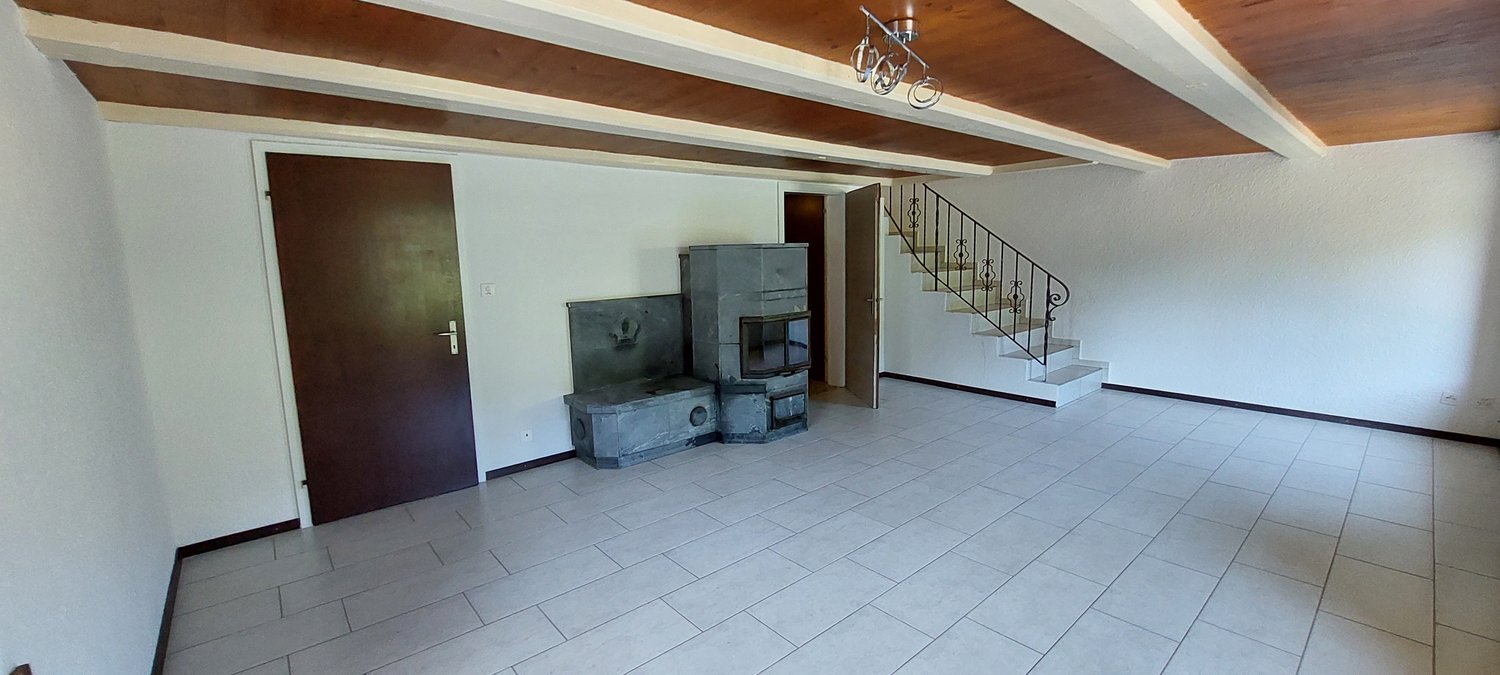 white tile flooring, white walls, wooden beams, metal handrail, metal door, fireplace, power outlet