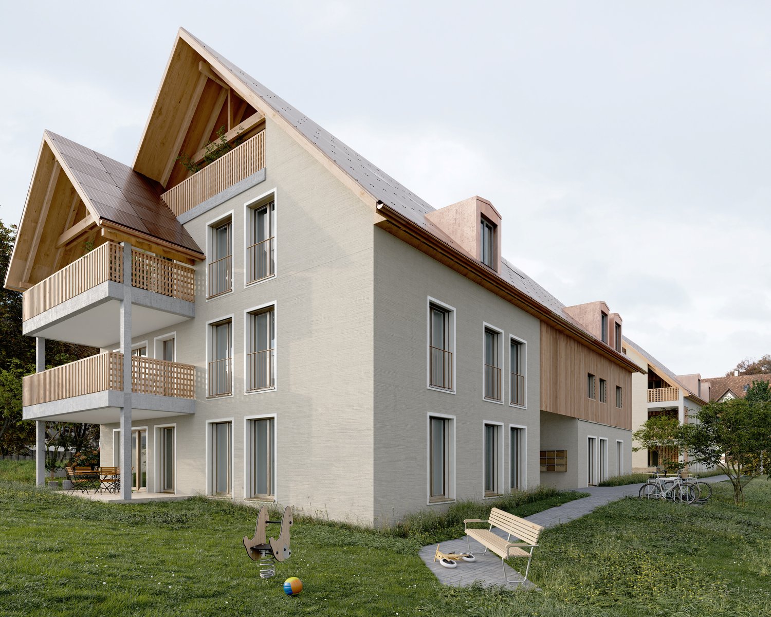 3-story apartment building with a modern, mixed-material design featuring wooden accents and balconies. The building has a grassy area with benches and children's toys in the foreground.