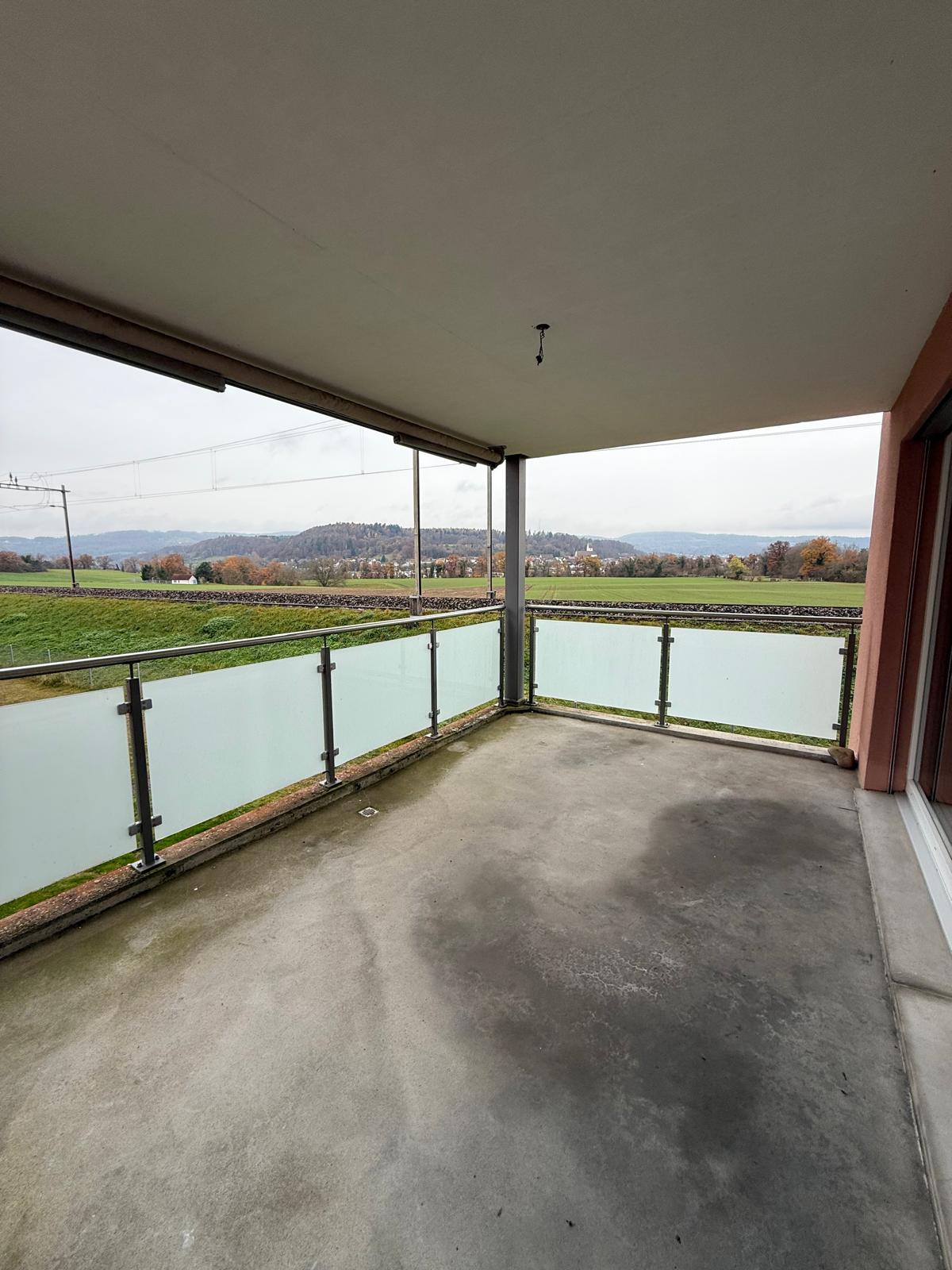 terraced balcony, metal railings, panoramic views of countryside