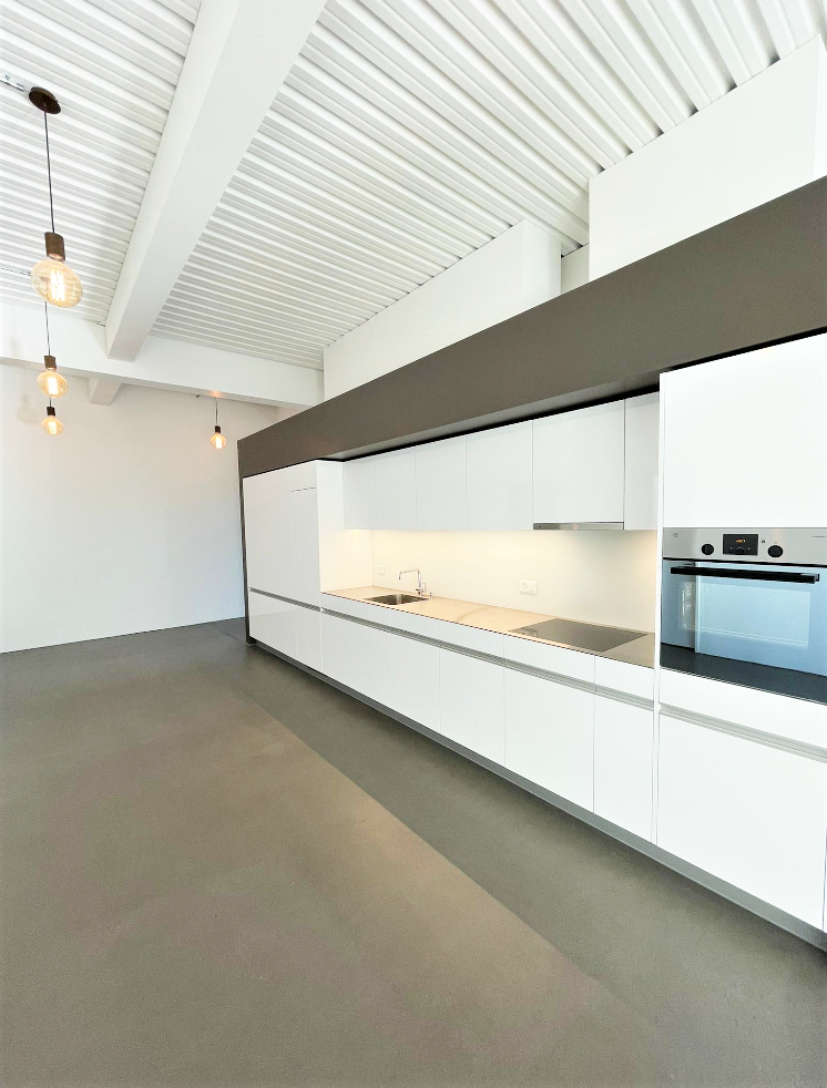 fully equipped kitchen, open layout, white cabinets, stainless steel appliances, modern lighting