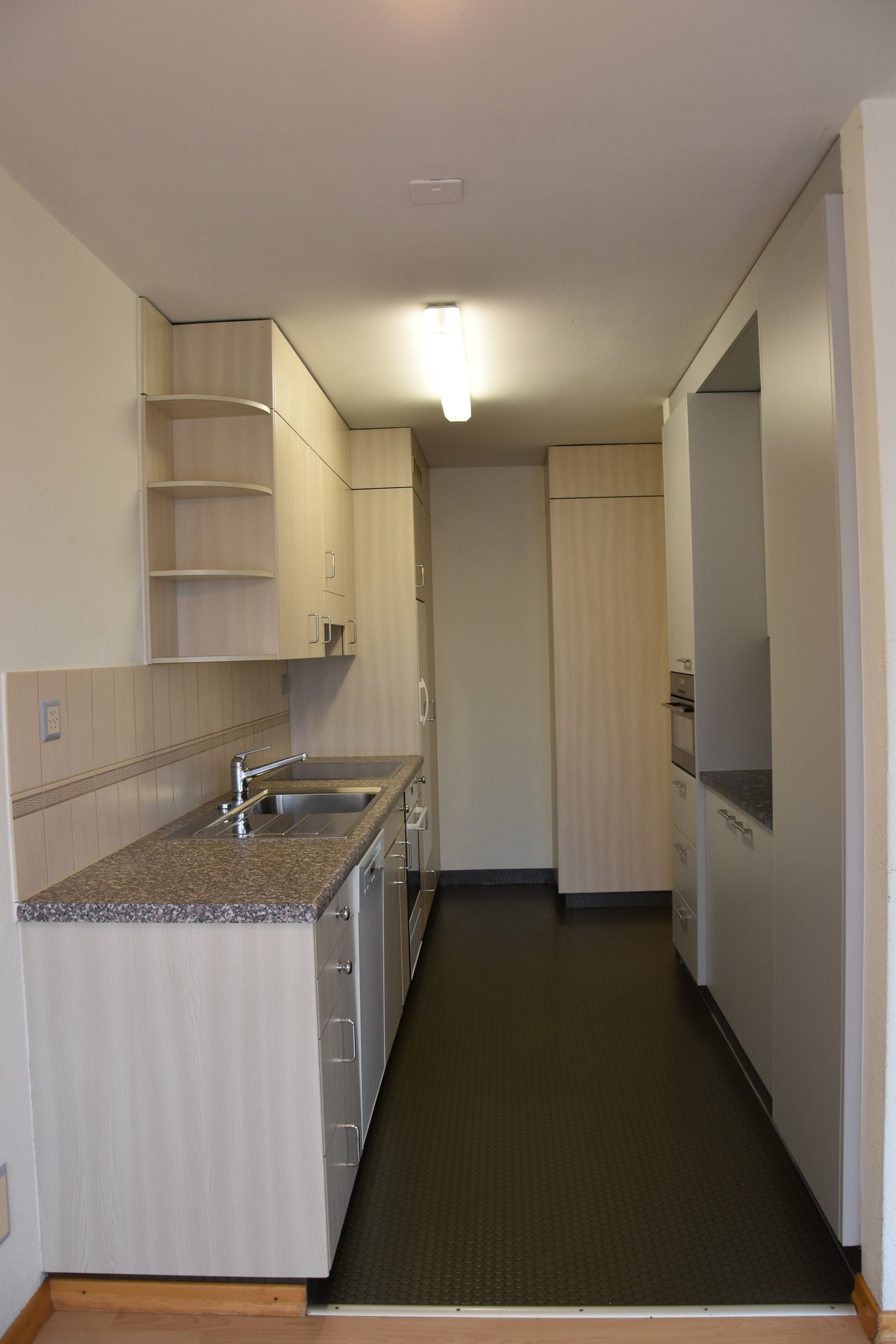 Modern kitchen with granite countertop, stainless steel appliances, and ample storage space