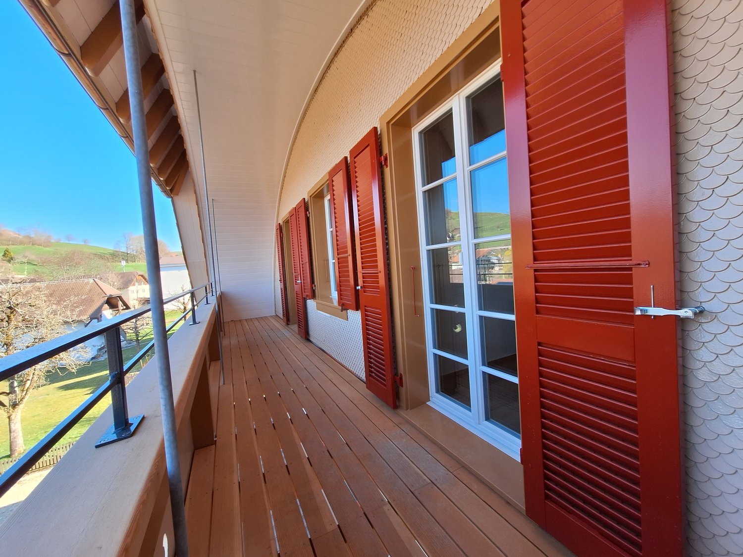 wooden floor, red shutters, glass doors, metal railings, view of the outside
