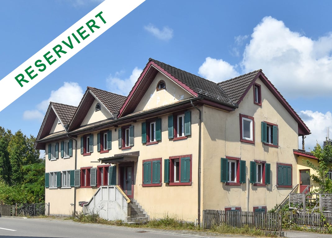 2 story house, red trim, green shutters, large windows, entrance stairs