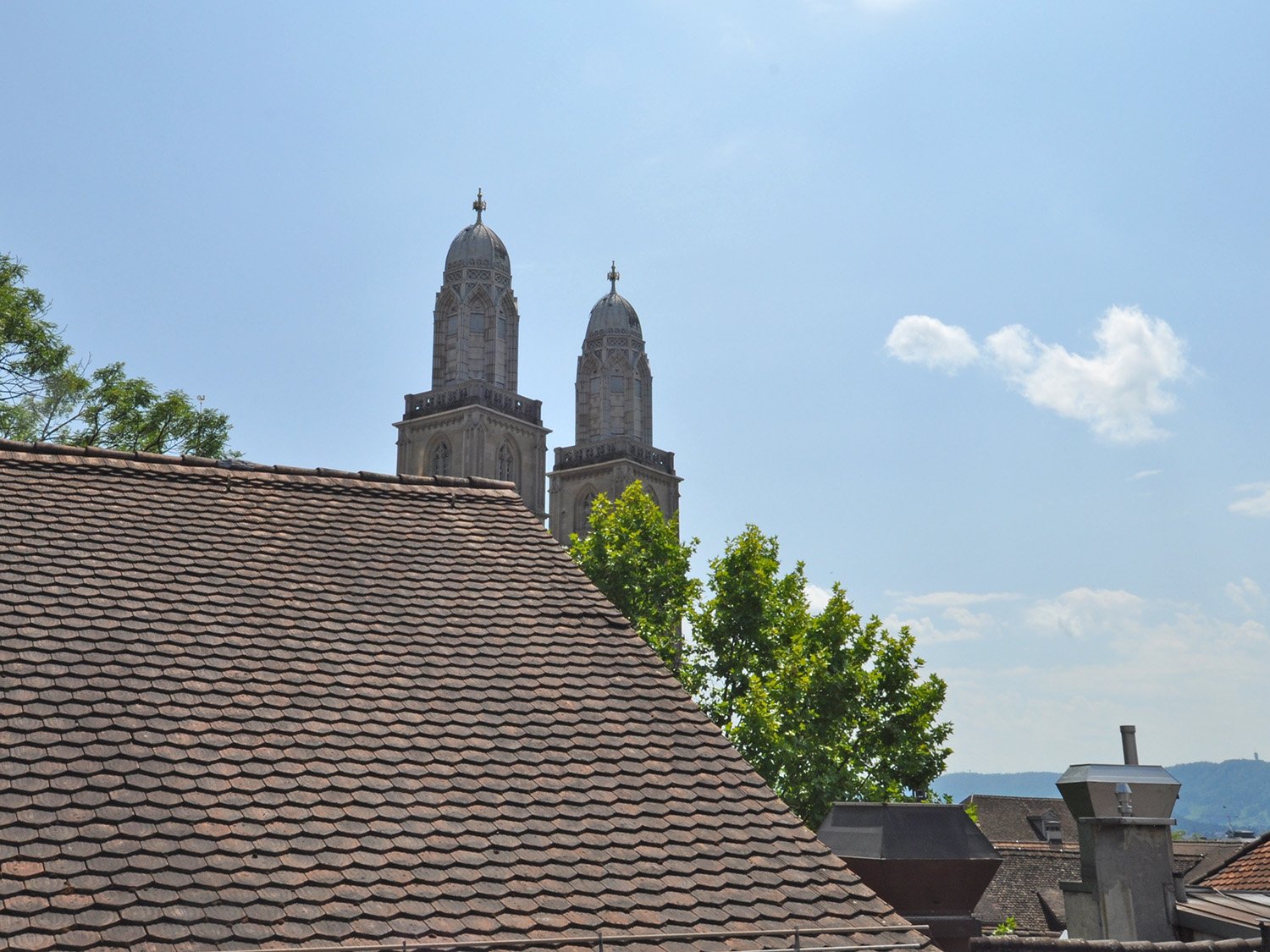 Old building with red roof, view of two towers from a window