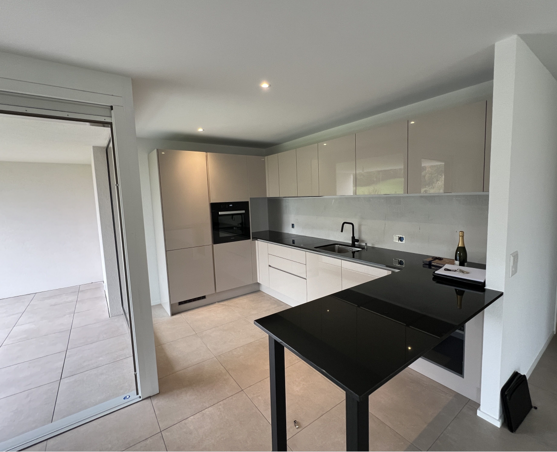 Kitchen: white cabinets, tile flooring, black countertop, built-in oven and dishwasher