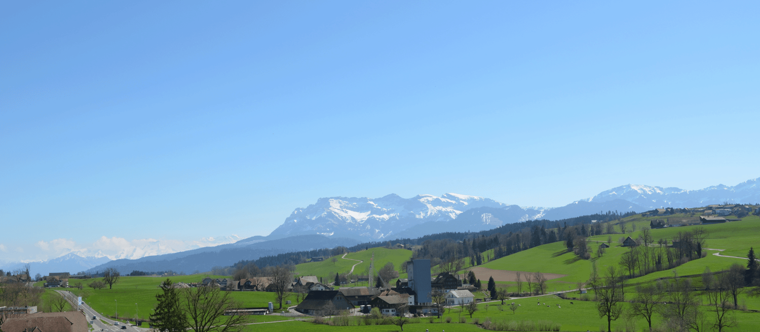 Mountains, hills, village, road, wide green valley.