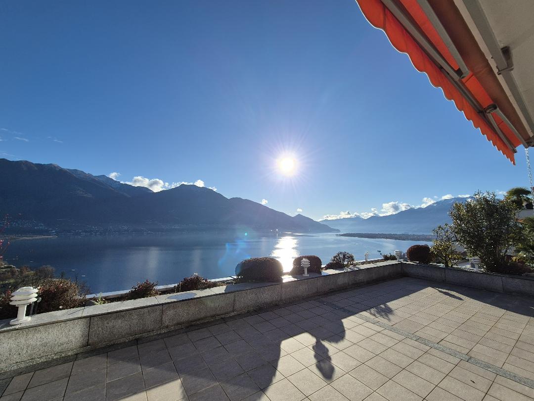 tiled floor, view of lake and mountains, shadow, railing, orange awning