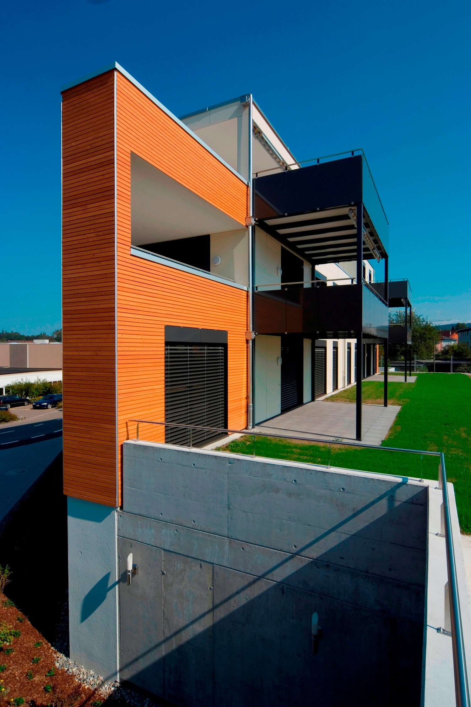 modern 2-story house, wooden wall, concrete wall, large balcony, entrance area, glass doors
